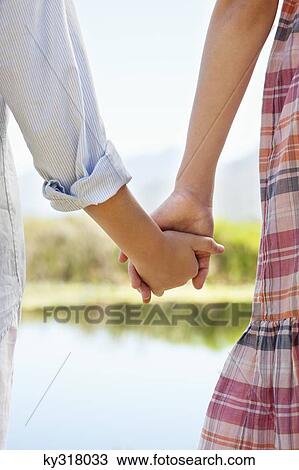 Close-up of siblings holding hands View Large Photo Image Stock Image - Close-up of siblings holding hands. Fotosearch