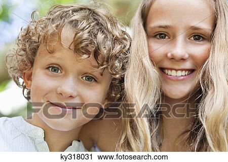 Close-up of smiling brother and his sister View Large Photo Image Stock Image - Close-up of smiling brother and his sister. Fotosearch