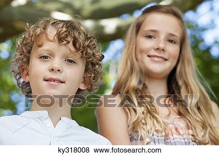 Close-up of smiling brother and his sister View Large Photo Image Stock Photo - Close-up of smiling brother and his sister. Fotosearch