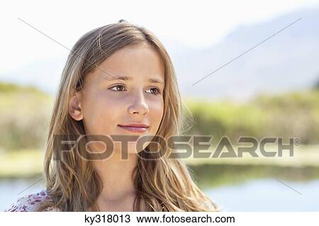 Close-up of smiling girl day dreaming View Large Photo Image Stock Image - Close-up of smiling girl day dreaming. Fotosearch
