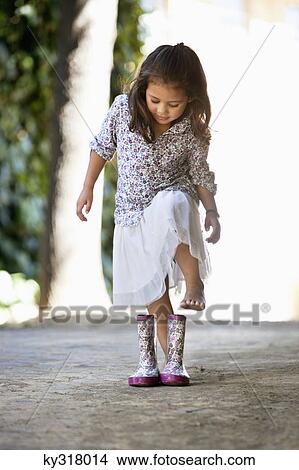 Picture - Cute girl wearing shoes. Fotosearch