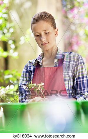 Picture - Girl gardening and thinking. Fotosearch