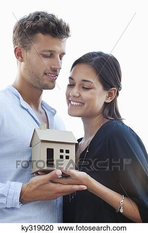 Cute young couple holding small model house View Large Photo Image Stock Image - Cute young couple holding small model house. Fotosearch