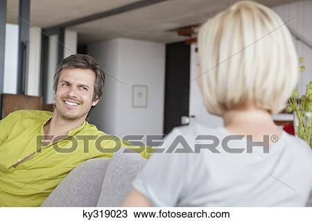 Man smiling at his wife View Large Photo Image Stock Image - Man smiling at his wife. Fotosearch