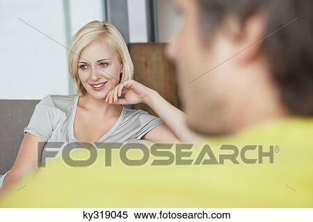 Stock Photography - Woman contemplating with man in foreground. Fotosearch