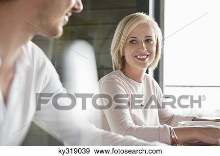 Woman looking at her husband and smiling View Large Photo Image Stock Photo - Woman looking at her husband and smiling. Fotosearch