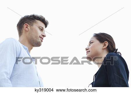 Young couple looking at each other View Large Photo Image Picture - Young couple looking at each other. Fotosearch