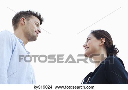 Young couple looking at each other View Large Photo Image Picture - Young couple looking at each other. Fotosearch