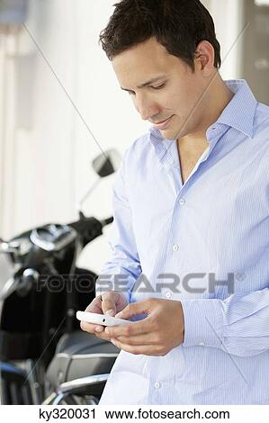 Man text messaging on a mobile phone View Large Photo Image Stock Image - Man text messaging on a mobile phone. Fotosearch