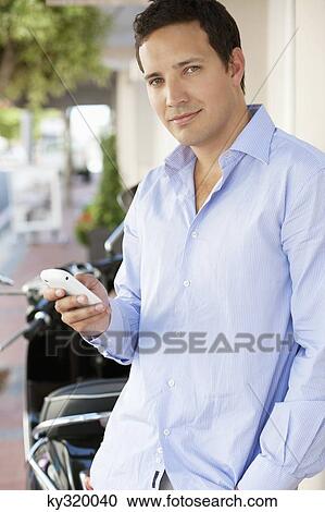 Man text messaging on a mobile phone View Large Photo Image Stock Image - Man text messaging on a mobile phone. Fotosearch