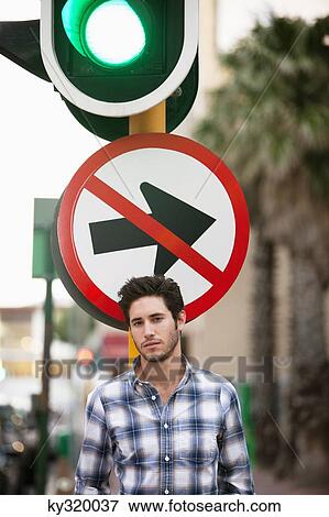 Man with "No Entry" sign and traffic light in the background View Large Photo Image Stock Photo - Man with "No Entry" sign and traffic light in the background. Fotosearch