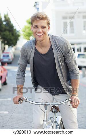 Portrait of a young man cycling View Large Photo Image Stock Image - Portrait of a young man cycling. Fotosearch