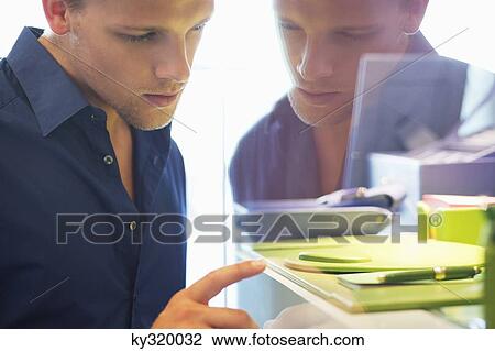 Side profile of a young man doing window shopping View Large Photo Image Stock Image - Side profile of a young man doing window shopping. Fotosearch