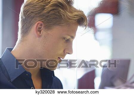 Side profile of a young man doing window shopping View Large Photo Image Stock Photo - Side profile of a young man doing window shopping. Fotosearch
