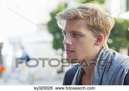 Side profile of a young man thinking View Large Photo Image Stock Photograph - Side profile of a young man thinking. Fotosearch