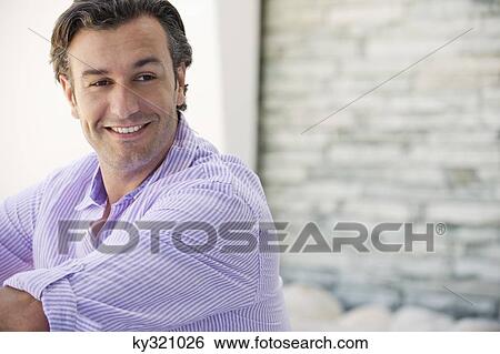 Close-up of a mid adult man smiling View Large Photo Image Stock Photograph - Close-up of a mid adult man smiling. Fotosearch