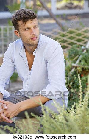 Contemplative man sitting in garden View Large Photo Image Stock Photography - Contemplative man sitting in garden. Fotosearch
