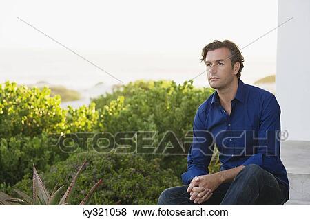Mid adult man thinking View Large Photo Image Stock Photo - Mid adult man thinking. Fotosearch