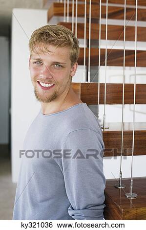 Portrait of a young man smiling View Large Photo Image Stock Photograph - Portrait of a young man smiling. Fotosearch