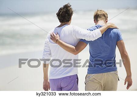 Rear view of two men walking with their arms around each other View Large Photo Image Stock Image - Rear view of two men walking with their arms around each other. Fotosearch