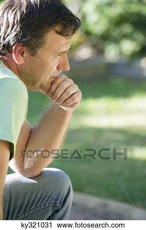 Side profile of a mature man thinking with hand on chin View Large Photo Image Stock Image - Side profile of a mature man thinking with hand on chin. Fotosearch