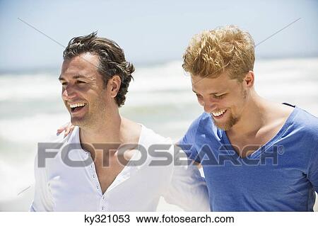 Stock Image - Two men laughing together. Fotosearch