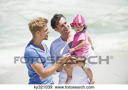 Two men playing with a girl View Large Photo Image Stock Photo - Two men playing with a girl. Fotosearch
