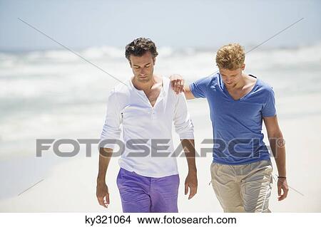 Two men walking on the beach View Large Photo Image Picture - Two men walking on the beach. Fotosearch