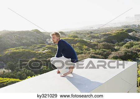 Young man looking at view from the terrace of a house View Large Photo Image Stock Photo - Young man looking at view from the terrace of a house. Fotosearch