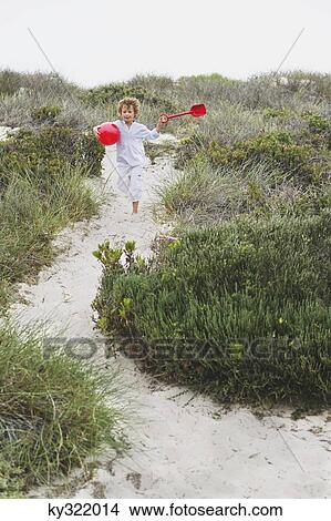 Boy running on the beach View Large Photo Image Picture - Boy running on the beach. Fotosearch