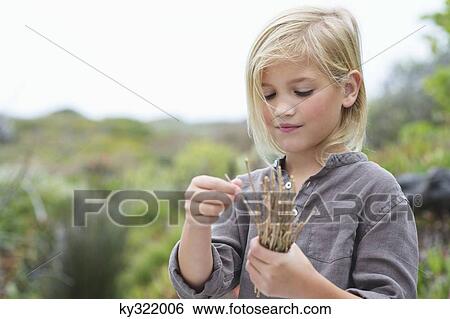 Close-up of a girl holding wooden sticks View Large Photo Image Stock Photograph - Close-up of a girl holding wooden sticks. Fotosearch