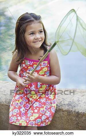 Little girl sitting by the swimming pool with net in hand View Large Photo Image Stock Photography - Little girl sitting by the swimming pool with net in hand. Fotosearch