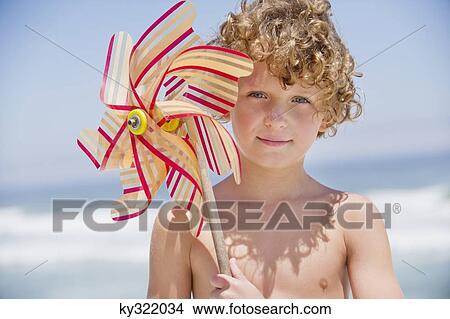 Portrait of a boy holding a pinwheel View Large Photo Image Picture - Portrait of a boy holding a pinwheel. Fotosearch