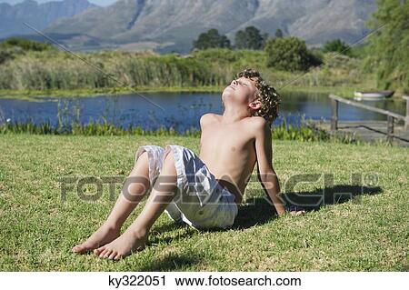 Shirtless little boy sitting with his eyes closed against mountain View Large Photo Image Stock Image - Shirtless little boy sitting with his eyes closed against mountain. Fotosearch