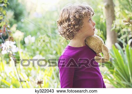 Side profile of a little boy looking away in a garden View Large Photo Image Stock Image - Side profile of a little boy looking away in a garden. Fotosearch