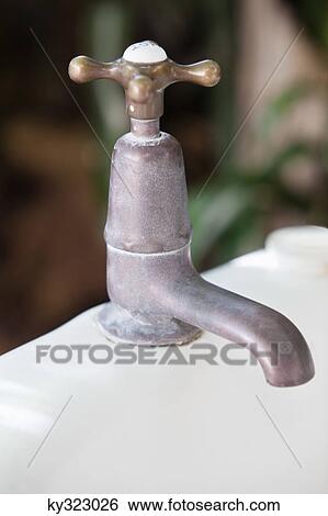 Stock Photograph - Close-up of a brass faucet. Fotosearch