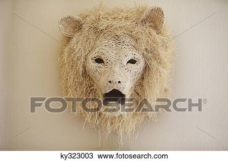 Stock Image - Close-up of a lion head decorated on a wall. Fotosearch