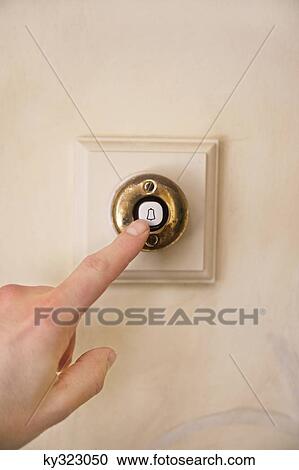 Close-up of a person's hand ringing door bell View Large Photo Image Stock Image - Close-up of a person's hand ringing door bell. Fotosearch