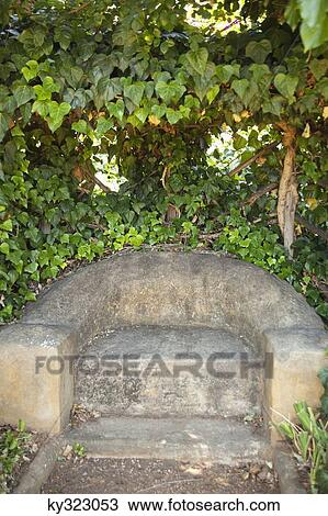 Stone seat in a garden View Large Photo Image Stock Image - Stone seat in a garden. Fotosearch