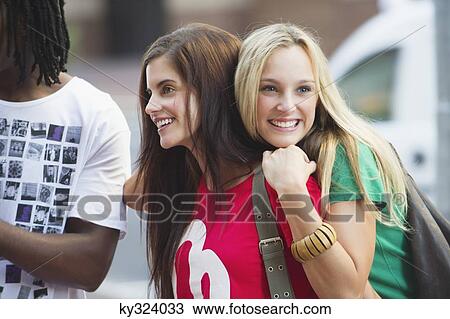 Friends standing together and smiling View Large Photo Image Stock Image - Friends standing together and smiling. Fotosearch