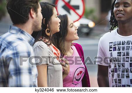 Friends standing together and smiling View Large Photo Image Stock Photograph - Friends standing together and smiling. Fotosearch