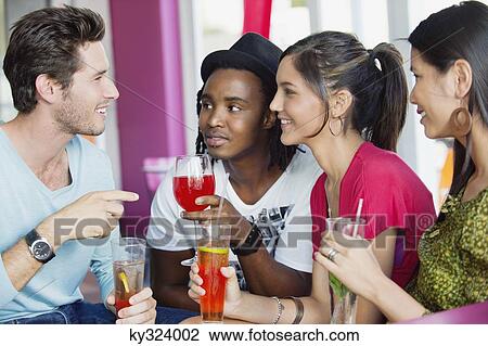 Friends with drinks in a restaurant View Large Photo Image Stock Image - Friends with drinks in a restaurant. Fotosearch
