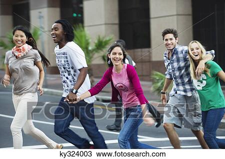 Group of young friends crossing road View Large Photo Image Stock Image - Group of young friends crossing road. Fotosearch