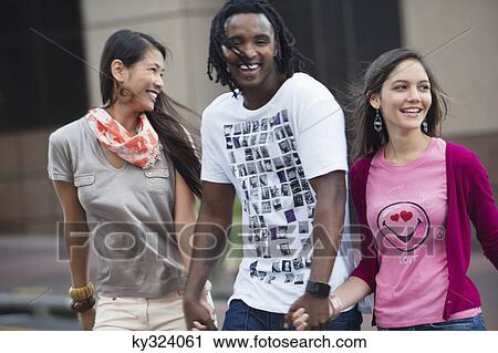 Man with his friends crossing road View Large Photo Image Stock Image - Man with his friends crossing road. Fotosearch