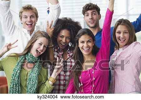 Multi-ethnic university students standing together and cheering View Large Photo Image Picture - Multi-ethnic university students standing together and cheering. Fotosearch