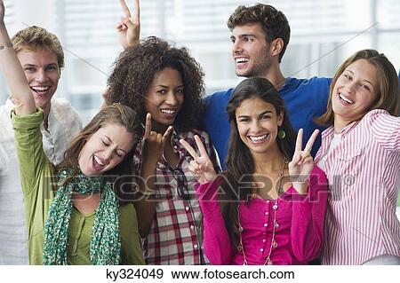 Multi-ethnic university students standing together and cheering View Large Photo Image Stock Photo - Multi-ethnic university students standing together and cheering. Fotosearch