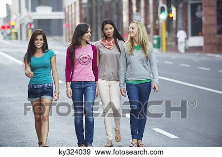 Portrait of a beautiful woman walking with friends on the road View Large Photo Image Stock Photo - Portrait of a beautiful woman walking with friends on the road. Fotosearch