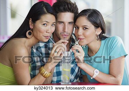 Portrait of friends sharing lime juice in a restaurant View Large Photo Image Stock Image - Portrait of friends sharing lime juice in a restaurant. Fotosearch
