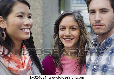 Portrait of friends standing outdoors View Large Photo Image Stock Image - Portrait of friends standing outdoors. Fotosearch