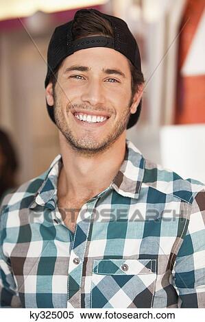 Close-up of a handsome man smiling at a cafe View Large Photo Image Stock Photography - Close-up of a handsome man smiling at a cafe. Fotosearch